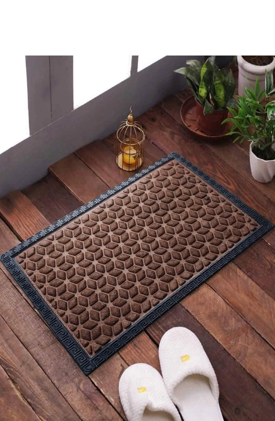 Brown honeycomb rubber door mat with a decorative border, on a wooden floor
